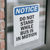 Do Not Stand While Bus Is In Motion Sign