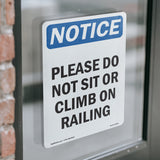 Please Do Not Sit Or Climb On Railing Sign